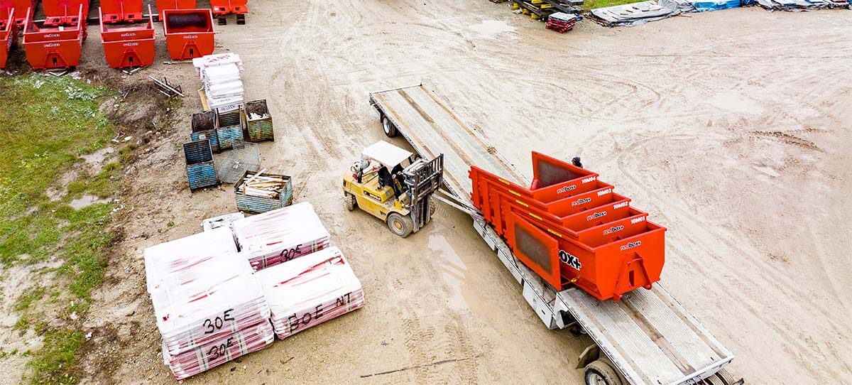 Field full of redbox+ dumpster containers